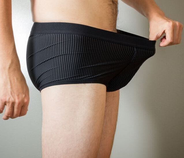 a man looks down at his underpants after penile enlargement surgery